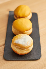 sweet donut sprinkled with powdered sugar on a plate closeup