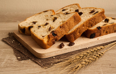 raisin bread lay on wooden plate put on sackcloath,raisin bread,delicious raisin bread