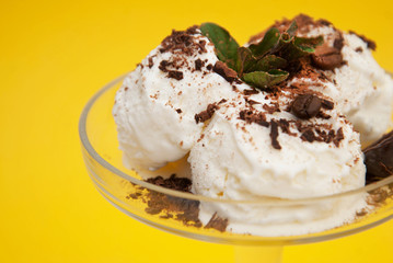 Vanilla Ice Cream with Chocoalte Topping Scoop in cup on Summer Yellow background
