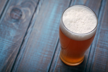 Pale ale on blue wood