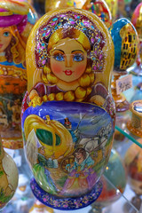 Souvenir dolls on the shelf for sale. Russian Matryoshka Nesting Dolls Set in Classic Clothes at Gift Shop Shelf.  Souvenir from Russia.