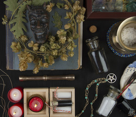 Occult altar with Pan's face, wreath of hops 
