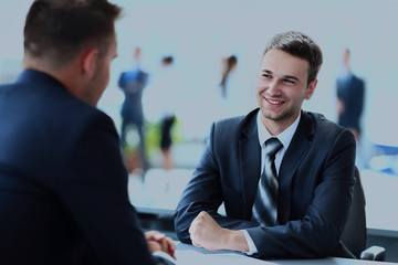 Happy business people talking on meeting at office