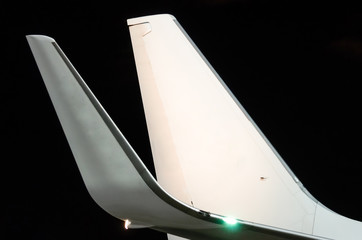 Wings and tail with night lights at the airport