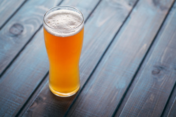 Pale ale on blue wood