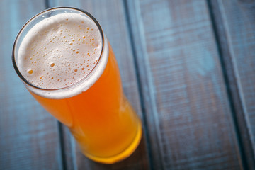 Pale ale on blue wood
