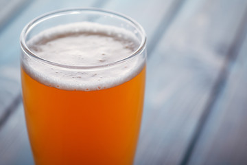 Pale ale on blue wood
