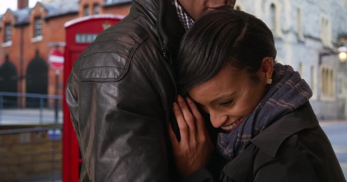 African girlfriend and boyfriend show their love for each other while in Windsor, England, Pretty African-American woman tenderly embraces her boyfriend, 4k