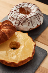 Close-up shot of a marble cake  with vanilla  glaze. Homemade, sugar free, wholegrain, walnut and pistachio. Vanilla icing.