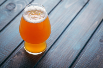 Pale ale on blue wood