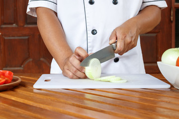 Chef preparing vegetable for cooking.