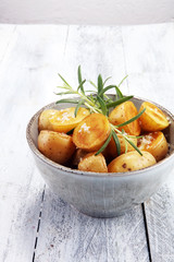 Roasted potato with fresh rosemary in a bowl