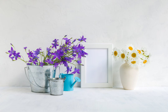 Mockup with a white frame and summer flowers