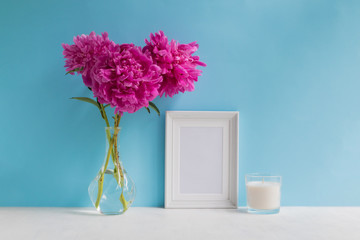 Mockup with a white frame and pink peonies