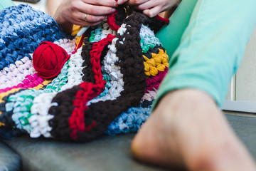 The woman is crocheting.