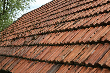 Old tiled roof on a stone house / Details