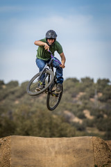 Sportsman flying on a bike in nature