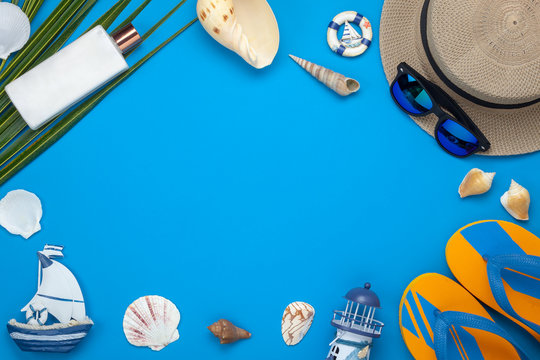 Table top view aerial image of accessory for summer travel holiday background.Flat lay essential objects for beach vacation on modern blue paper at office desk.free space for creative design text.