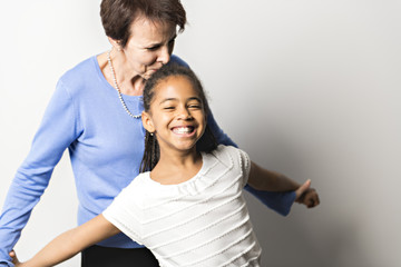 Fototapeta premium black girl child with grandmother in studio white background