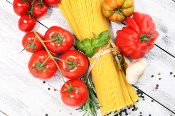 Italian food background with pasta, basil and tomato, health or vegetarian concept.
