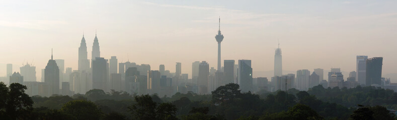 panorama view of beautiful kuala lumpur cityscape skyline in the hazy or foggy morning enviroment and buildings in silhouette