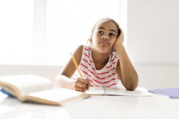 Black girl doing homework at home