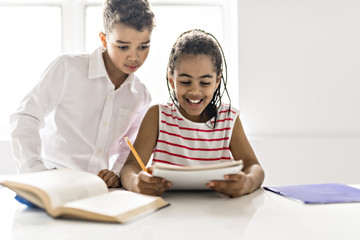 Two Black child doing homework at home