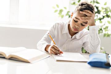Black boy doing homework at home