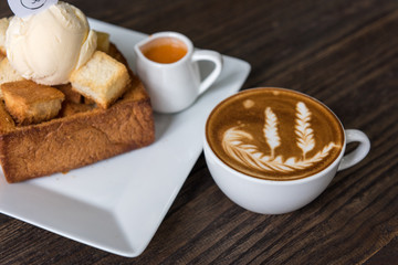 Hot coffee latte art cup  on wooden table