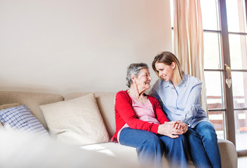 An elderly grandmother with an adult granddaughter at home.