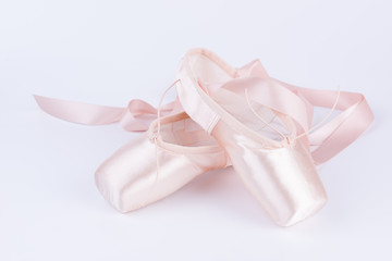 Pink ballet shoes isolated on a white background