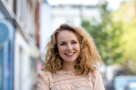 Adult Female Smiling Outdoors In City