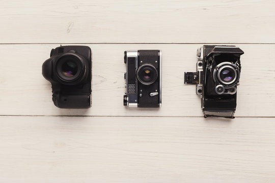 Three different cameras on white table