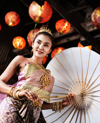 The beauty  lady in Traditional Thai Dress ,with umbrella,