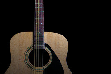 Obraz na płótnie Canvas New acoustic guitar on black background