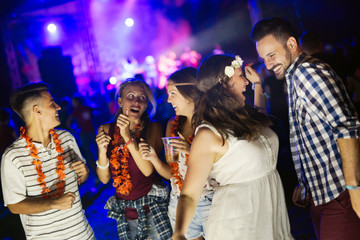 Group of friends having great time on music festival