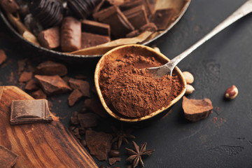 Cocoa bowl and crushed chocolate pieces on gray background