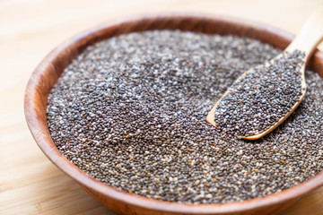 Chia seeds in a wooden spoon on the table
