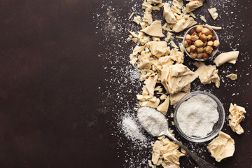 Crushed white chocolate pieces and truffles on dark background