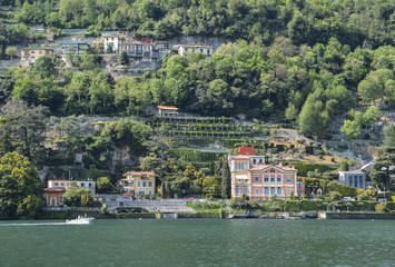 Fototapeta na wymiar Panoramic view of quaint traditional waterfront houses on majestic Lake Como, Lombardy, Italy.