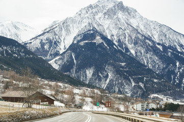 A steep mountain above the road.