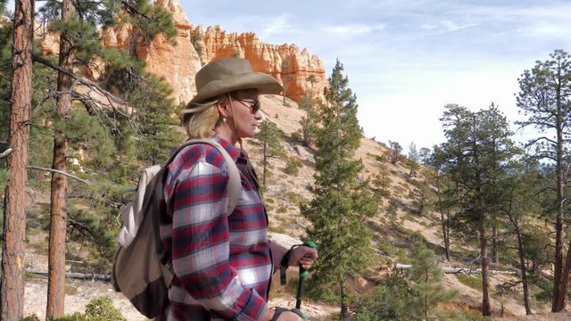 A Side View Of A Hiker Woman Walking Forward In The Bryce Canyon Rocks And Pines