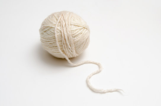 White ball of yarn on a white table