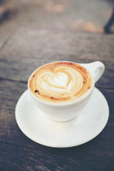 Cappuccino coffee cup on wood background