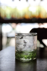 Water in glass in wood background