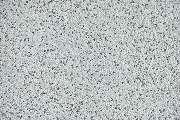 Background texture of polished stone showing the random distribution of constituent minerals forming a speckled pattern