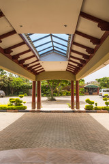 Marquise of an entrance portico with wooden beams and a glass part