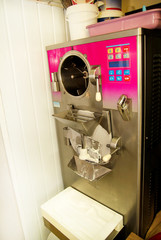 Maker machine for production ice cream. Industrial preparation of creamy ice cream. Beautiful dessert, sweets, fruit flavors, chocolate, vanilla.