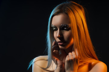 Beautiful crying naked blonde girl, covers topless big chest with her hands. Avant-garde makeup,...