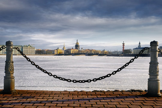 a winter evening panorama of the embankment of St. Petersburg with a view of the Admiralty, Isaac's Cathedral, the Winter Palace, Vasilievsky Island with rastral columns and the frozen Neva River